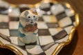 Cute cat ceramic doll in checkered tray