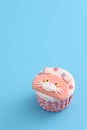 Cute cat cupcake isolated in blue background Royalty Free Stock Photo