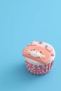 Cute cat cupcake isolated in blue background Royalty Free Stock Photo
