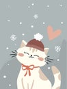 Cute cat with a red hat and bow sitting in falling snow with a pink heart above. Royalty Free Stock Photo