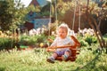 Cute Caucasian baby girl with blonde hair having fun on a swing on the playground in a sunny summer park. The concept of Royalty Free Stock Photo