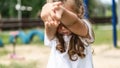 Cute caucasian baby, little girl crying on the playground in the park. Sad emotion of a child Royalty Free Stock Photo