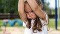 Cute caucasian baby, little girl crying on the playground in the park. Sad emotion of a child Royalty Free Stock Photo