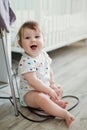 Cute caucasian baby in a white cloth playing