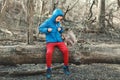 Cute Caucasian boy feeding grey squirrel in park. Adorable little kid giving food nuts to wild animal in forest. Child learning