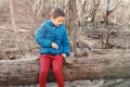 Cute Caucasian boy feeding grey squirrel in park. Adorable little kid giving food nuts to wild animal in forest. Child learning