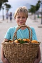 Cute caucasian boy wicker basket full of fresh orange fruits Royalty Free Stock Photo