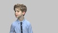Cute caucasian child boy on gray background.