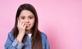 Cute caucasian emotional child girl in a jeans jacket on a pink background Royalty Free Stock Photo