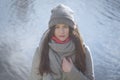 Cute Caucasian girl at the background of river or lake outdoors. Portrait of brunette beautiful woman looking at camera Royalty Free Stock Photo