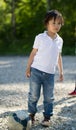 Cute caucasian toddler boy playing with soccer ball in the park at sunny day Royalty Free Stock Photo