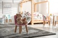 Cute chair with bunny ears and teddy bear in children`s bedroom