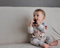 A cute charming baby is playing with a toy Royalty Free Stock Photo