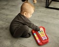 A cute charming baby is playing with a toy Royalty Free Stock Photo