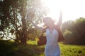 Cute charming girl in summer in the field. Young woman is happy and feels free outdoors. Royalty Free Stock Photo