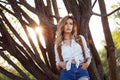 Cute charming girl in summer in the field. Young woman is happy and feels free outdoors Royalty Free Stock Photo