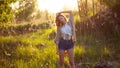 Cute charming girl in summer in the field. Young woman is happy and feels free outdoors Royalty Free Stock Photo