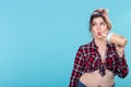 Cute charming young woman in retro clothes is drinking a cocktail from a straw posing against a blue background with Royalty Free Stock Photo