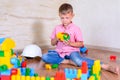 Cute cheeky young boy playing with building blocks Royalty Free Stock Photo