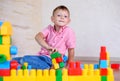 Cute cheeky young boy playing with building blocks Royalty Free Stock Photo