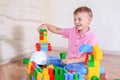 Cute cheeky young boy playing with building blocks Royalty Free Stock Photo