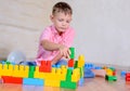 Cute cheeky young boy playing with building blocks Royalty Free Stock Photo