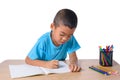 Cute cheerful child drawing using color pencil while sitting at table isolated on white background Royalty Free Stock Photo