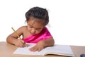 Cute cheerful child drawing using color pencil while sitting at table isolated on white background Royalty Free Stock Photo