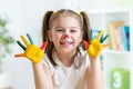 Cute cheerful child with painted hands and face