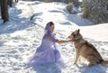 Horizontal photo of a beautiful girl with a dog on a background of a winter forest Royalty Free Stock Photo