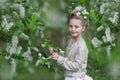 Cute cheerful girl in the flowered cherry-tree garden Royalty Free Stock Photo