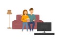 Cute cheerful laughing couple watching funny tv show, sitting on sofa at home