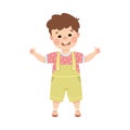 Cute cheerful little boy showing thumb up gesture with both hands. Happy brown haired boy dressed jumpsuit standing with