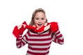 Cute cheerful little girl wearing striped knitted sweater, scarf and mittens isolated on white background. Winter clothes.