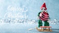 Cute Cheerful Santas Helper Elf Loading Christmas Bauble Onto Santas Sleigh. North Pole Christmas Scene. Santas Workshop. Royalty Free Stock Photo