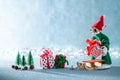 Cute Cheerful Santas Helper Elf Loading Christmas Gifts Onto Santas Sleigh. North Pole Christmas Scene. Santas Workshop. Royalty Free Stock Photo