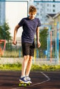 Cute cheerful smiling Boy in blue t shirt sneakers riding on yellow skateboard. Active urban lifestyle of youth, training, hobby, Royalty Free Stock Photo