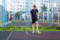 Cute cheerful smiling Boy in blue t shirt sneakers riding on yellow skateboard. Active urban lifestyle of youth, training, hobby Royalty Free Stock Photo