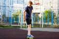 Cute cheerful smiling Boy in blue t shirt sneakers riding on yellow skateboard. Active urban lifestyle of youth, training, hobby, Royalty Free Stock Photo