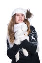 Cute cheerful teenage girl posing in the studio. Showing emotions. Wearing knitted woolen sweater, scarf, hat and mittens. Royalty Free Stock Photo