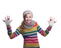 Cute cheerful teenage girl wearing colorful striped sweater, scarf, gloves and hat isolated on white background. Winter clothes.