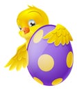 Cute chick and painted chocolate Easter egg Royalty Free Stock Photo