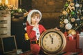 Cute child with alarm clock christmas. New year clock, time for christmas night. Kid boy is waiting for the New Year. Royalty Free Stock Photo