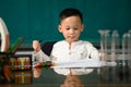 Cute child Asian boy doing homework. Clever kid drawing at desk. Schoolboy. Elementary school student drawing at workplace. Kid Royalty Free Stock Photo