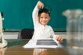 Cute child Asian boy using Magnifying glass. Clever kid drawing at desk. Schoolboy. Elementary school student drawing at workplace