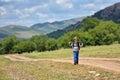 Cute child boy with backpack walking on a little path in mountains. Hiking kid Royalty Free Stock Photo