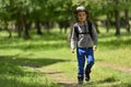 Cute child boy with backpack walking on a little path in mountains. Hiking kid Royalty Free Stock Photo