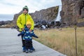 Cute child, boy, enjoying a sunny day Oxararfoss Waterfall in Thingvellir National Park rift valley, Iceland autumntime Royalty Free Stock Photo