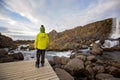 Cute child, boy, enjoying a sunny day in Oxararfoss Waterfall in Thingvellir National Park rift valley, Iceland Royalty Free Stock Photo