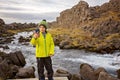 Cute child, boy, enjoying a sunny day in Thingvellir National Park rift valley,taking pictures with cellphone, Iceland Royalty Free Stock Photo